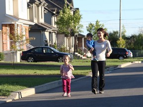 Gina Guzzo walks with children Joseph and Olivia. Vaudreuil-Dorion's hot real estate market has swelled the city's coffers