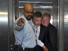 Toronto Mayor Rob Ford (RIGHT) arrives at his City Hall offices as allegations into the use of crack have come to light via a video, Friday May 17, 2013.
[Peter J. Thompson/National Post]