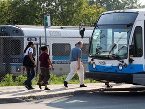 Commuters head to buses after getting off AMT train at Roxboro-Pierrefonds commuter train station.