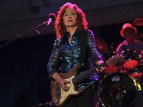 American blues singer-songwriter and slide guitar player Bonnie Raitt performs during the Timbre Rock and Roots concert on Friday March 22, 2013 in Singapore. (AP Photo/Wong Maye-E)