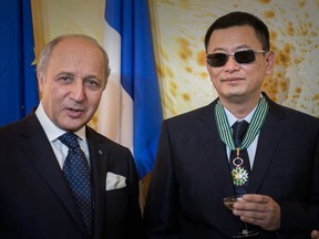 Hong Kong  film director Wong Kar Wai, right, poses with French Foreign Minister Laurent Fabius in Hong Kong on May 5, 2013. Wong was appointed a Commander of France's Order of Arts and Letters by the French minister.    (PHILIPPE LOPEZ/AFP/Getty Images)