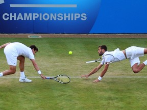 Edouard Roger-Vasselin of France (L) and Benoit Paire of France in action during the Men's Doubles second round match against Colin Fleming of Great Britain and Jonathan Marray of Great Britain on day four of the AEGON Championships at Queens Club on June 13, 2013 in London, England.  (Photo by Clive Brunskill/Getty Images)