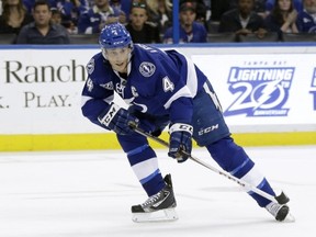 FILE - In this Feb. 2, 2013 file photo, Tampa Bay Lightning center Vincent Lecavalier moves down the ice against the New York Rangers in an NHL hockey game in Tampa, Fla. The Lightning are buying out the contract of Lecavalier, a move that will create salary cap space and make one of the stars of the franchise's only Stanley Cup champion a free agent next month. (AP Photo/Chris O'Meara, File)