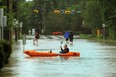 A Calgarian paddled a boat along a street in the Elbow Park area of Calgary after the Elbow River spilled over the banks and flooded a large area surrounding it on Friday. Prime Minister Stephen Harper was on his way to southern Alberta on Friday to tour areas devastated by flooding that has displaced tens of thousands of people.
(Colleen De Neve/Calgary Herald)