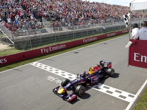 Sebastian Vettel of Germany crosses the finish line to win the Formula One Grand Prix du Canada in Montreal on Sunday, June 9, 2013. The Canadian Press/Paul Chiasson