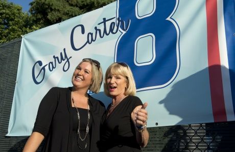 Sandy Carter, wife of former Montreal Expos Gary Carter, and her daughter  Kimmy acknowledge applauds from the crowd during a ceremony prior to a  pre-season game between the Toronto Blue Jays and