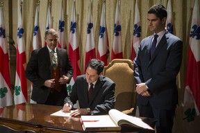 In this file photo from November of last year, council speaker Harout Chitilian, right, looks on as newly elected interim mayor Michael Applebaum, centre, signs in as replacement for former mayor Gerald Tremblay. Now that Applebaum has resigned, Chitilian is perceived as the front runner among the candidates to replace him in a vote by council that will be overseen by city clerk  Yves Saindon, left. (Dario Ayala/THE GAZETTE)