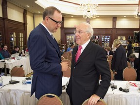 Bell CEO George Cope, left, chats with Astral CEO Ian Greenberg, right, during a break at the Canadian Radio-Television and Telecommunication Commission hearings into the Astral-Bell merger Friday, May 10, 2013 in Montreal.
