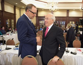 Bell CEO George Cope, left, chats with Astral CEO Ian Greenberg, right, during a break at the Canadian Radio-Television and Telecommunication Commission hearings into the Astral-Bell merger Friday, May 10, 2013 in Montreal.