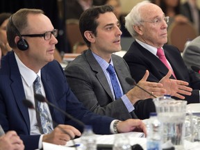Bell Canada Chief Legal Officer Mirko Bibic, center, makes a point as Astral CEO Ian Greenberg, right, and Bell CEO George Cope, left, look on at the Canadian Radio-Television and Telecommunication Commission hearings into the Astral-Bell merger Friday, May 10, 2013 in Montreal.
