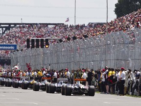 F1 cars line up before the start of last year's Formula One Canadian Grand Prix at the Circuit Gilles Villeneuve. The race is considered the city's unofficial start of summer, a lost weekend to those who love peace and quiet and a tribute to conspicuous consumption excess by anyone who doesn't have tickets to the event. (Dario Ayala/THE GAZETTE)