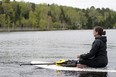 Retreat participant meditates on the lake (photo by Carrie MacPherson)