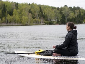 Retreat participant meditates on the lake (photo by Carrie MacPherson)