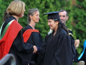 Valedictorian and multiple award winner Zhu Yin Xu is congratulated by faculty members.