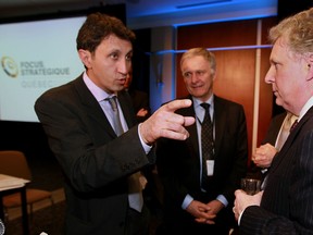 In this file photo from 2010, Marcel Cote (centre) listens as Quebec Solidaire MNA Amir Khadir (left) speaks to then Quebec Premier Jean Charest. Cote, who may announce his intention this week to seek the mayoralty of Montreal, is no stranger to politicians. But the extent of his own political skills remains to be seen.(MONTREAL GAZETTE/John Mahoney)