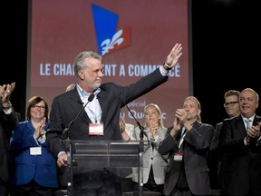 Quebec Liberal Party Leader Philippe Couillard waves to applauding delegates delegates at the end of hois opening speech last weekend  at the Quebec Liberal Party general council in Quebec City. A Gazette-Le Devoir survey suggests Couillard and his party are outpacing the Parti Quebecois in popularity and gaining serious support among francophone voters.  THE CANADIAN PRESS/Jacques Boissinot