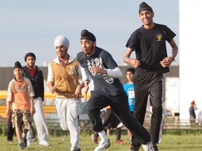 Local Sikhs play pick-up soccer next to the Gurdwara Guru Nanak Darbar in the Lasalle area last week in the wake of a Quebec Soccer Federation ban on turbans and other Sikh head coverings. The Canadian Soccer Association today called on Quebec's federation to drop the ban and bring itself  into line with the rest of the country. (THE GAZETTE / John Kenney)