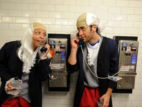 Actors dressed as Benjamin Franklin talk on pay phones on June 29, 2013 in New York City. In honor of July 4th, Virgin Mobile enlisted 100 Benjamin Franklins to take over New York City.