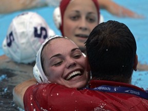 Canada's Christine Robinson hugs Ahmed El-Awadi, then, assistant coach, after Canada's bronze medal win over Russia at 2005 FINA championships in Montreal.