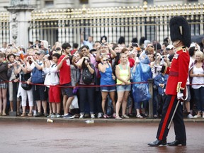 The changing of the guard takes place outside Buckingham Palace the day after the birth of the son of Prince William, Duke of Cambridge and Catherine, Duchess of Cambridge. The Duchess of Cambridge yesterday gave birth to a boy weighing 8lb 6oz, with Prince William at her side. The baby, as yet unnamed, is third in line to the throne and becomes the Prince of Cambridge.  (Photo by Dan Dennison/Getty Images)