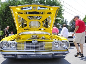 Under the hood of a 1964 Chevrolet Impala.