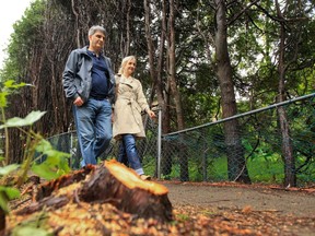 Dan Kratochvil and Darlene George on the path on their property. They want to install a new chain-link fence.