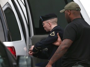 U.S. Army Private First Class Bradley Manning is escorted by military police as he leaves his military trial after he was found guilty of 20 out of 21 charges, July 30, 2013 at Fort George G. Meade, Maryland. Manning was found not guilty of aiding the enemy but was convicted of wrongfully causing intelligence to be published on the internet and of sending hundreds of thousands of classified Iraq and Afghanistan war logs and more than 250,000 diplomatic cables to the website WikiLeaks while working as an intelligence analyst in Baghdad in 2009 and 2010.  (Photo by Mark Wilson/Getty Images)