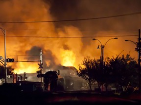 Firefighters douse blazes after a freight train loaded with oil derailed in Lac-Megantic early Saturday, sparking explosions that engulfed about 30 buildings in fire.  At least five persons are confirmed dead and 40 people are missing after the driverless oil tanker train derailed and exploded in the town centre. The disaster has focused the world's attention on the small town and revived the debate over rail safety in Canada. AFP PHOTO /  François Laplante-DelagraveFrançois Laplante-Delagrave/AFP/Getty Images