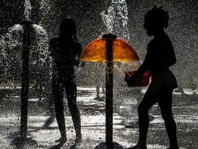 a water fountain provides welcome relief from Montreal's heat wave