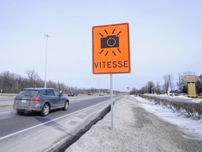 Temporary sign on Highway 40 near the Chateau Vaudreuil that indicates area is monitored by photo radar.