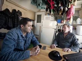 Allan Bassenden (right) speaks with Harminder Sodhi (right), in his trailer in , January, 2012. Sodhi started a facebook site to help the family.