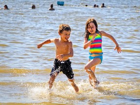 Megan Tannenbaum-Wise chases her brother Samuel through the water.