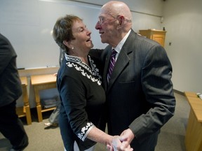 Pointe Claire mayor Bill McMurchie embraces his wife Denise Chartrain, whom he calls his secret weapon, after he announced his decision on August 5, 2013, not to run in the November 3, 2013 municipal election.