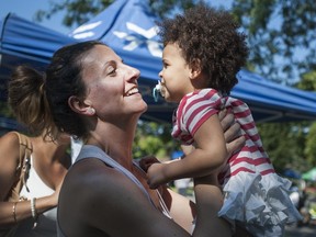 Lisanne Dion plays with Jayden, 2, during a block party in Kirkland.