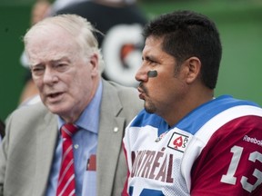 Als team doctor David Mulder talks to injured QB Anthony Calvillo during Saturday's game at Mosaic Stadium.
Liam Richards/Canadian Press