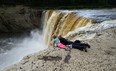 Stephane Sevigny and daughter Serena, 7, of Yellowknife view Alexandra Falls on the Hay River south of Hay River, Northwest Territories on Tuesday, August 20, 2013. THE CANADIAN PRESS/Sean Kilpatrick