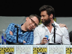 Eat your hearts out, ladies! Director Bryan Singer, left, rests his head on  actor Hugh Jackman's shoulder at  Comic-Con International 2013 at San Diego Convention Center on July 20, 2013 in San Diego, California.  (Photo by Kevin Winter/Getty Images)