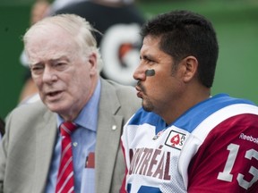 The now infamous photo of concussed Als QB Anthony Calvillo, trying to shake off the cobwebs while talking to Dr. David Mulder.
Liam Richards/Canadian Press