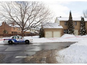 A Montreal police cruiser sits in front of a home on Windermere Rd. in the Beaconsfield area of Montreal Sunday, February 6, 2011 that was broke into by intruders earlier in the day.