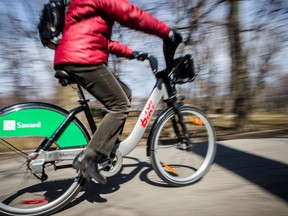 A Bixi bike is driven along the bicycle path in Lafontaine Park in the Plateau-Mont-Royal on April 15, 2013. The Bixi bicycle sharing system officially became active for this year on that date. Now, five months later, Bixi is $42 million in debt, running a deficit of $6.5 million and awaiting $5 million in payments from its international investors.(Dario Ayala / THE GAZETTE)