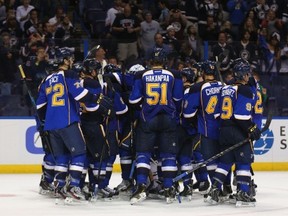 ST. LOUIS, MO - SEPTEMBER 21: Members of the St. Louis Blues celebrate their game-winning goal against the Dallas Stars during a preseason at the Scottrade Center on September 21, 2013 in St. Louis, Missouri.  The Blues beat the Stars 3-2 in overtime.  (Photo by Dilip Vishwanat/Getty Images)