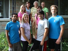Hazel Young, back row centre, stands on her front steps with Aid for Seniors staff.
