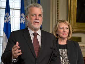 Quebec Liberal Leader Philippe Couillard announces his party's views over the new charter of Quebec values as Liberal MNA Christine St-Pierre, right, looks on. The Liberals believe the provincial government should be a secular institution, but don't think the PQ's proposed ban on religious symbols is the way to do it. THE CANADIAN PRESS/Jacques Boissinot