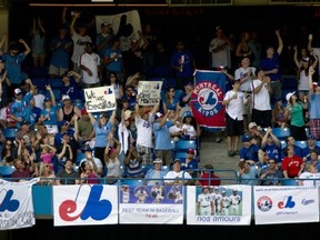 Montreal Expos fans fill an outfield section during AL action between the Toronto Blue Jays and the Tampa Bay Rays in Toronto on Saturday July 20, 2013. The Montreal fans hope to lure a major league team back to their city. THE CANADIAN PRESS/Frank Gunn