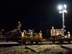 SEPTEMBER 10, 2013 -- A CP Rail crew replaces rotted wood ties with automated equipment on the main railway line near Sources Boulevard, Dorval, Wednesday, September 10, 2013. The double-track line carries both commuter and freight trains. Sections of rails are secured to the wooden ties with steel spikes by a pneumatic spiking machine - no one manually drives spikes anymore. (Frederic Hore/THE GAZETTE)