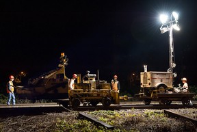 SEPTEMBER 10, 2013 -- A CP Rail crew replaces rotted wood ties with automated equipment on the main railway line near Sources Boulevard, Dorval, Wednesday, September 10, 2013. The double-track line carries both commuter and freight trains. Sections of rails are secured to the wooden ties with steel spikes by a pneumatic spiking machine - no one manually drives spikes anymore. (Frederic Hore/THE GAZETTE)