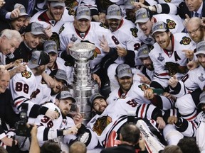 The Chicago Blackhawks pose with the Stanley Cup after beating the Boston Bruins 3-2 in Game 6 of the NHL hockey Stanley Cup Finals, Monday, June 24, 2013, in Boston. (AP Photo/Charles Krupa)