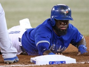 TORONTO, CANADA - AUGUST 31: Jose Reyes #7 of the Toronto Blue Jays dives back to first base in the sixth inning on a pick-off attempt during MLB game action against the Kansas City Royals on August 31, 2013 at Rogers Centre in Toronto, Ontario, Canada. (Photo by Tom Szczerbowski/Getty Images)