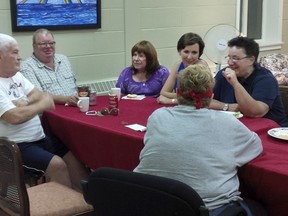 Beaconsfield United Church programs director Cindy Casey, in sleeveless top, chats with members of the LGBTQ adult group, inlcuding retired nurse Sharon Hill, wearing glasses. (Peter McCabe/THE GAZETTE)