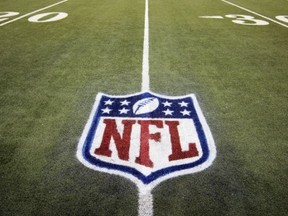 FILE - In this Nov. 20, 2011, file photo, an NFL logo is displayed on the Ford Field turf before an NFL football game between the Detroit Lions and the Carolina Panthers in Detroit. Google has been holding talks with the National Football League, raising speculation that the internet monolith is seeking new inroads into television. With Google sitting on a cash pile of $48 billion, the league's Sunday Ticket package is easily within its budget. The contract is currently held by DirecTV, but it expires at the end of the 2014 season. (AP Photo/Carlos Osorio, File)